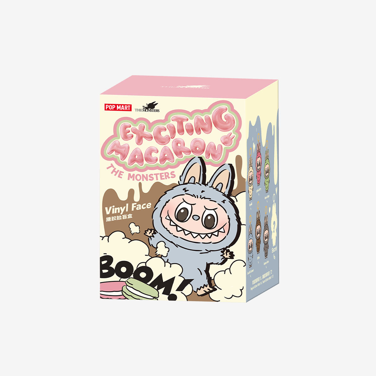 A rectangular box featuring the POP MART Labubu “Lychee Berry” Plush Keychain—The Monsters Pink Fleece Bunny Doll—with macarons, a cartoon monster, BOOM! on the front, and a limited edition collectible for fans to cherish.
