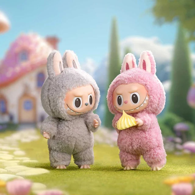 Two POP MART Labubu The Monsters “Exciting Macaron” limited edition plush keychain bunny dolls—one gray, one pink holding a yellow treat—stand on grass before a whimsical house. Designed by Kasing Lung. Vinyl face, from the 6-piece set.