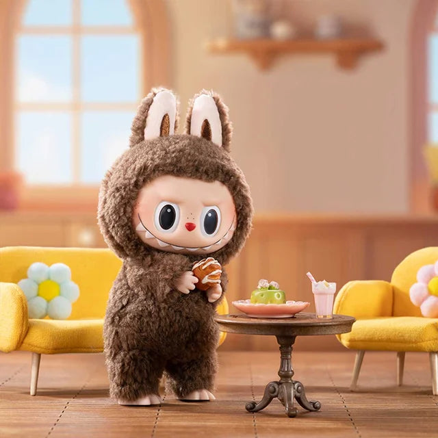 The Labubu Secret Edition “Chestnut Cocoa” Plush Keychain by Kasing Lung (POP MART) features a brown bunny in a cozy room with yellow sofas and flower pillows—a delightful collectible for any fan.