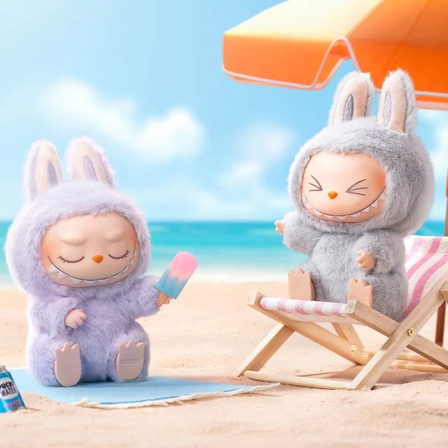The POP MART Labubu Have a Seat Series – Complete 6-Piece Plush Keychain Set features The Monsters in cute bunny costumes relaxing on the beach, with one holding a popsicle and another lounging under an orange umbrella.
