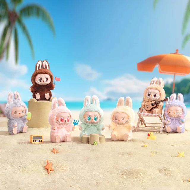 The POP MART Labubu Have a Seat Series – Complete 6-Piece Plush Keychain Set features collectible plushies posed on a sandy beach with sandcastles, a radio, starfish, and umbrella; one is playing guitar. No duplicates included.