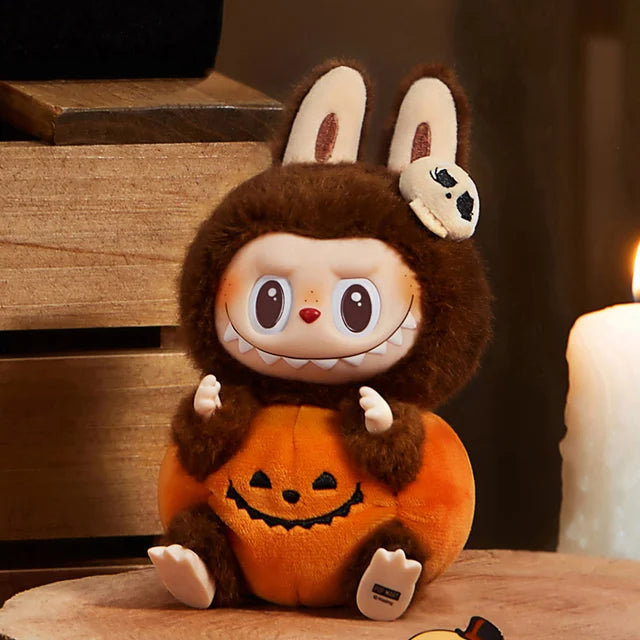 The POP MART THE MONSTERS – Happy Halloween Party Labubu 15cm Vinyl Plush Keychain (Pumpkin Edition) features Labubu in a pumpkin costume—an adorable Halloween collectible for fans.