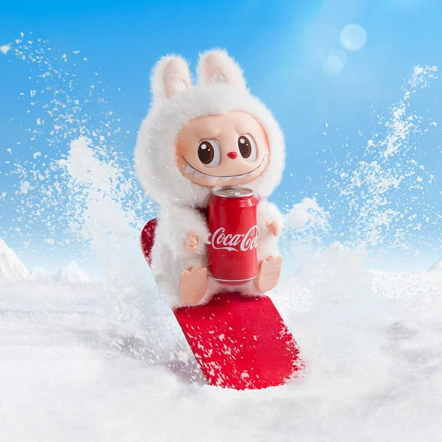 The POP MART Labubu Coca-Cola Happy Factor Plush Keychain – White Bunny Vinyl Collectible features Labubu in a white bunny outfit, holding a Coca-Cola can, riding a red snowboard—ideal for any Coca-Cola or Pop Mart fan.