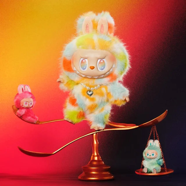 Three POP MART Labubu Big into Energy Series Plush Dolls—including the 37cm designer collectible—pose on a golden scale with bunny ears, set against a gradient red, orange, and black background.