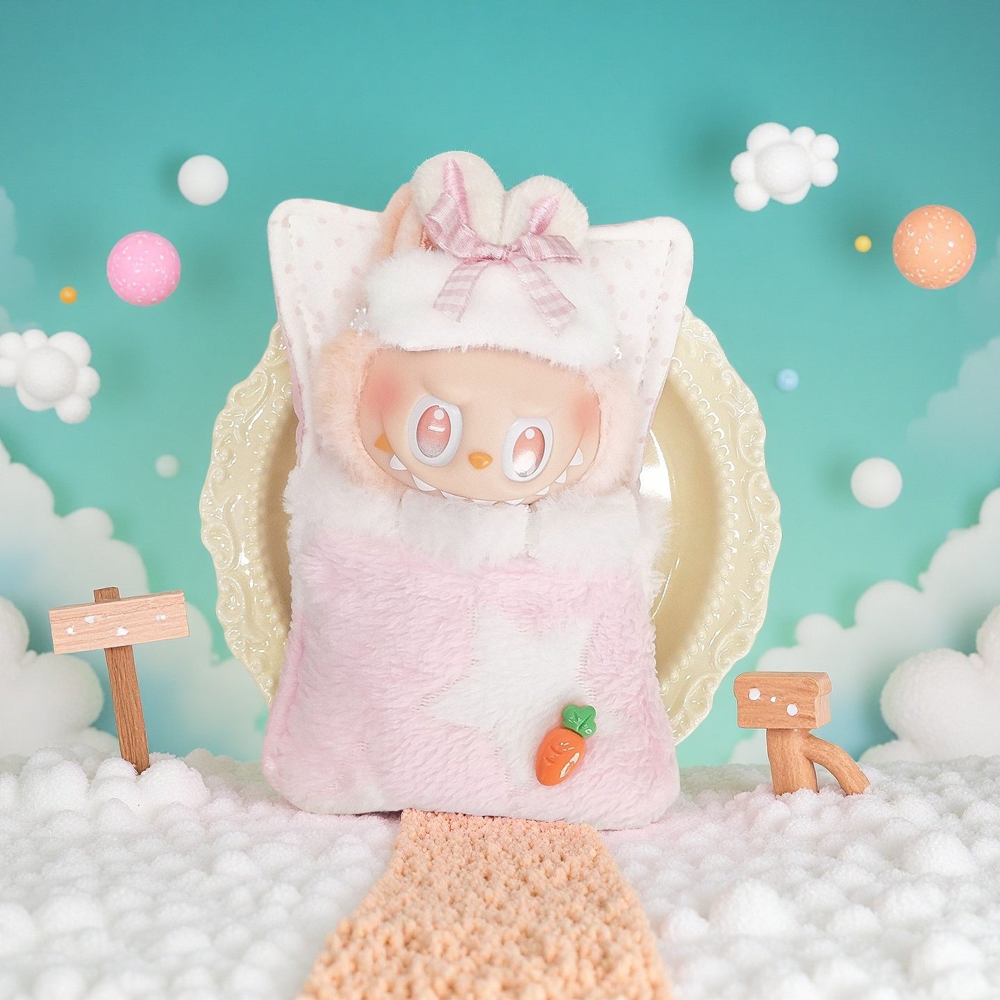 The ZoDoll Labubu Pink Bunny Sleeping Bag Plush Outfit with Carrot Pin sits on a plate among fluffy clouds and wooden signs against a pastel sky. Soft faux-fur plush fabric enhances its cozy, charming appeal.