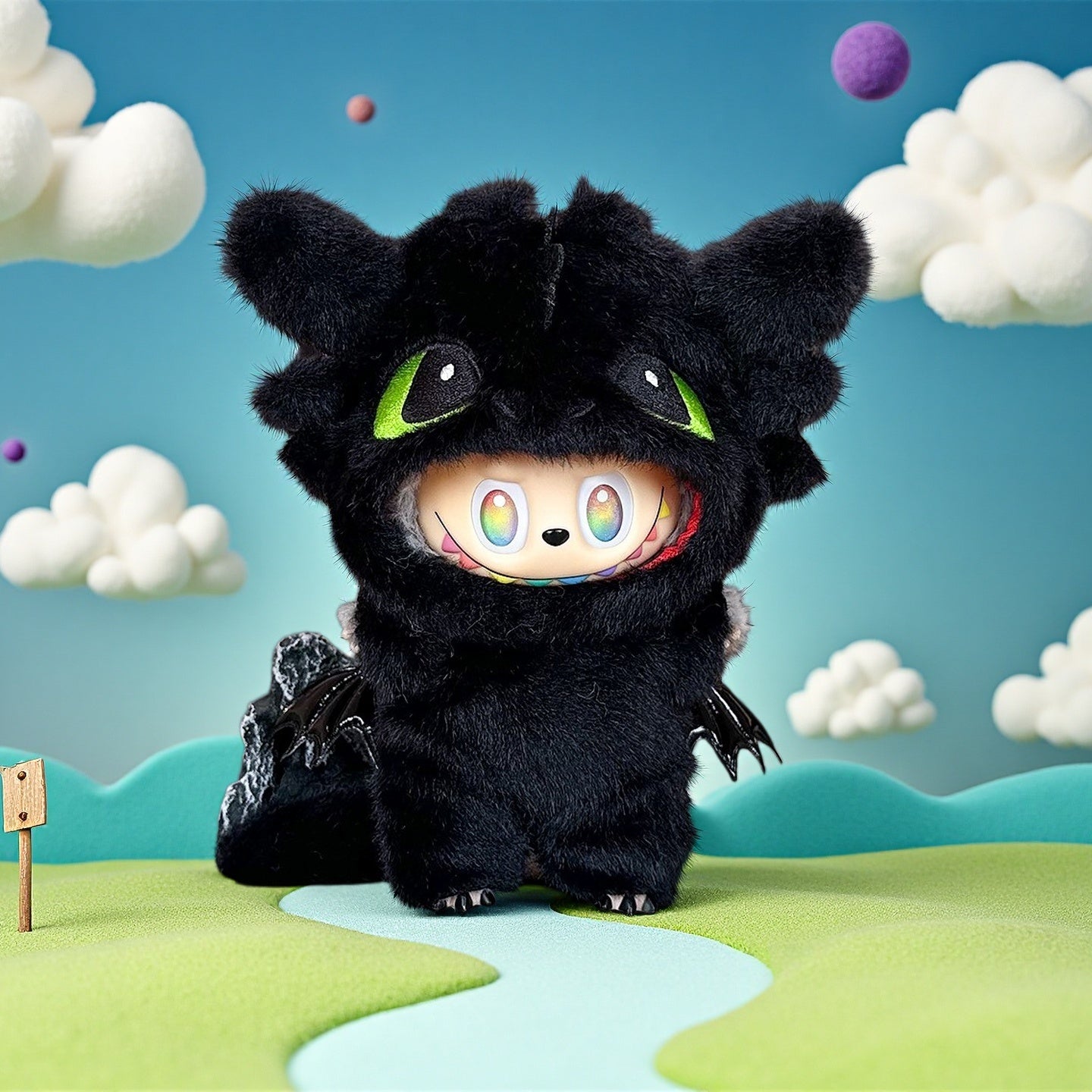 A ZoDoll toy figure wears the Labubu Night Fury Dragon Black Plush Full-Body Costume Outfit, posed on a pastel landscape with clouds and floating spheres in the background.