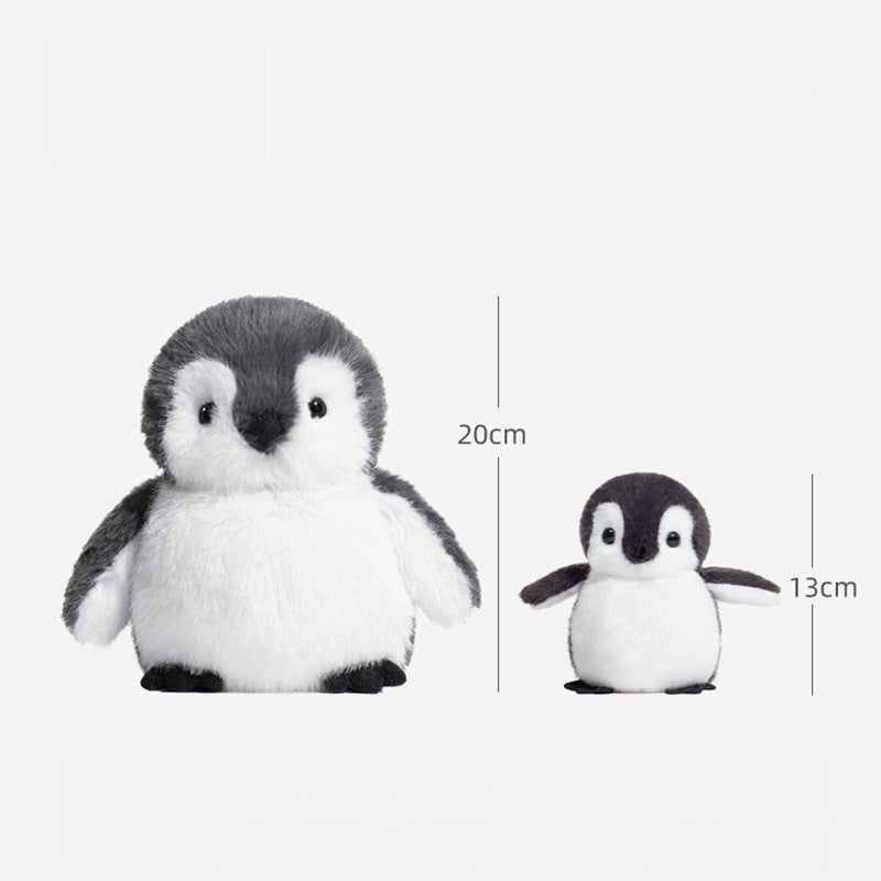 Two JOOKI baby penguin plush toys are shown side by side. The left is the 20cm Baby Penguin Plush Toy with grey and white fur, while the right plush is 13cm tall. Measurements are marked with vertical lines.
