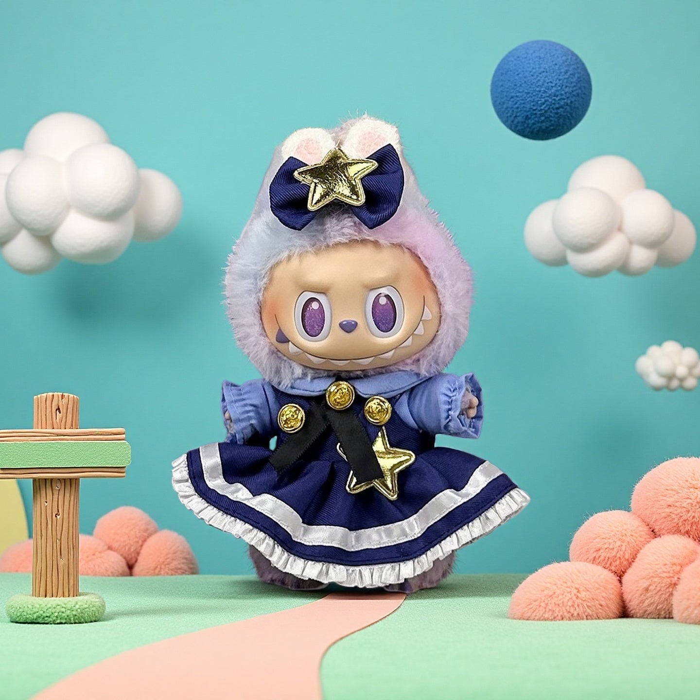 The ZoDoll Labubu Doll wears a navy blue Lolita dress with gold star and bow, standing on a pastel landscape with artificial clouds and round shapes against a light blue background.