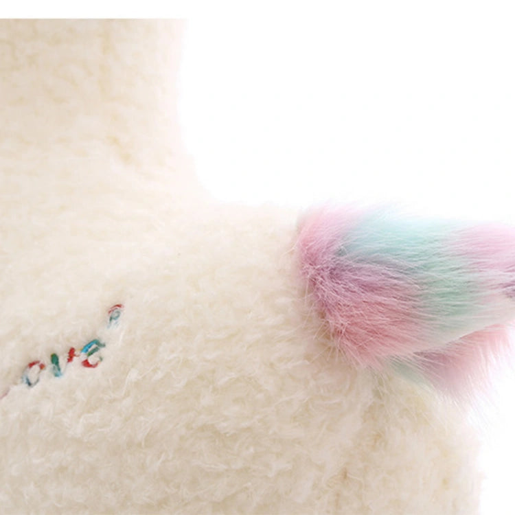 Close-up of the ZoDoll Cute Alpaca Plush Toy – a soft, stuffed alpaca doll with a fluffy white body, pastel rainbow tail, and small, colorful embroidered text for extra kawaii charm.