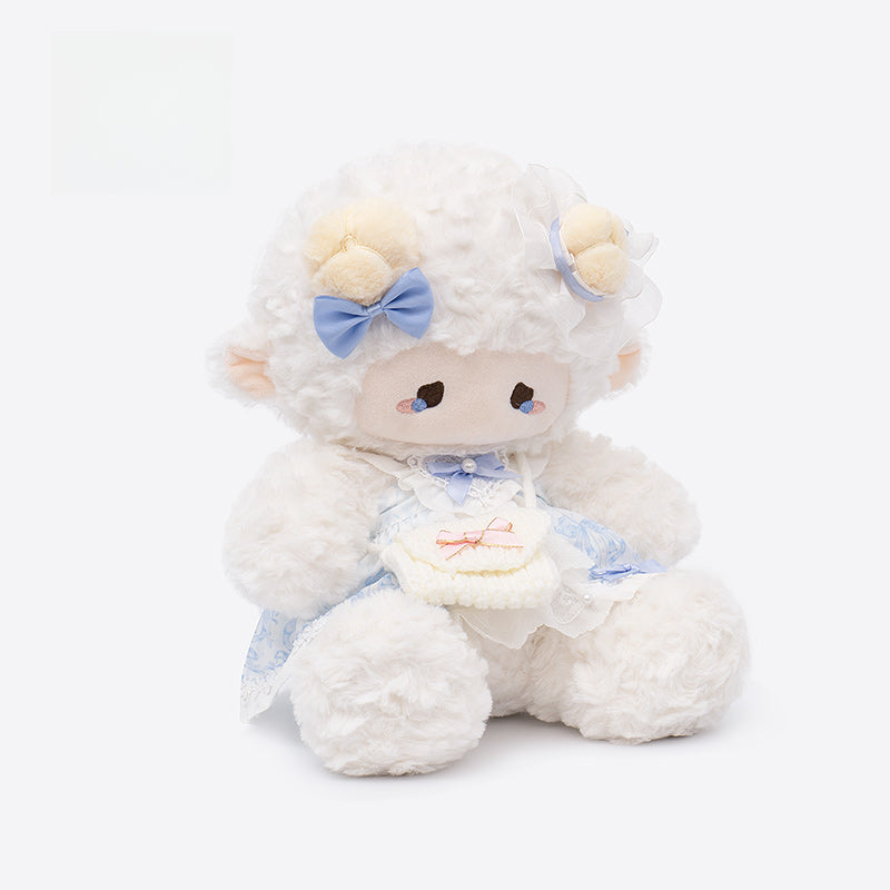 The ZEIO Dressed Lamb Plush Toy (29cm) is a soft sheep doll with yellow horns, a blue bow, and a frilly blue-and-white dress—perfect for nursery décor or as a collectible plush.
