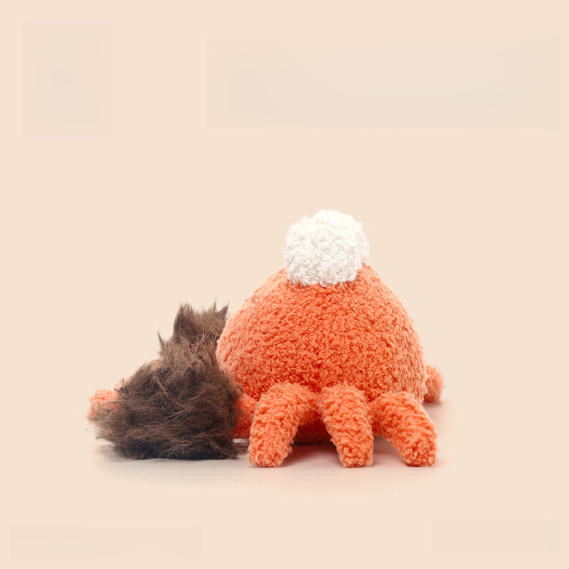 The 23cm Orange Crab Plush Toy by JOOKI features a soft, smiling design with six legs, fluffy claws, and a white pom-pom, perfect for sea animal lovers. Set against a plain beige background.