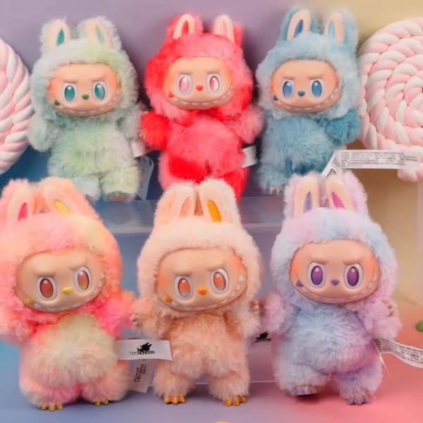 The Labubu “Big Into Energy” 6‑Piece Plush Keychain Set by POP MART, featuring Love, Happiness, Loyalty, Serenity, Hope & Luck characters in pastel bunny outfits, is displayed in two rows with large lollipops on a pastel backdrop.