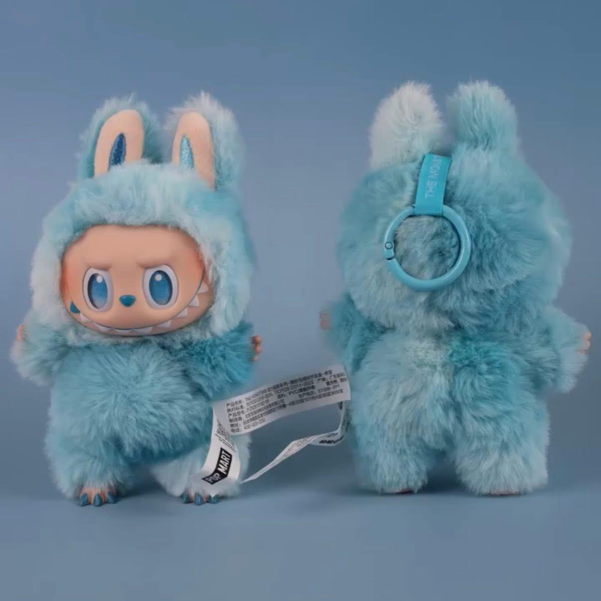 Two sky-blue Labubu “Hope” Bunny Plush Keychains from POP MART’s “Big Into Energy” series, one facing forward and one backward with tags, set on a blue background—a charming collectible bag charm for fans.