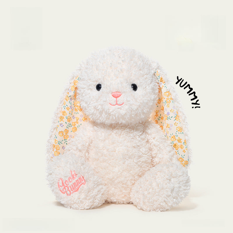 The 38cm White Bunny Plush Toy by JOOKI features floral-patterned ears, an embroidered paw, and sits upright—making it a delightful Easter gift for stuffed rabbit fans. "Yummy!" is written beside its right side.
