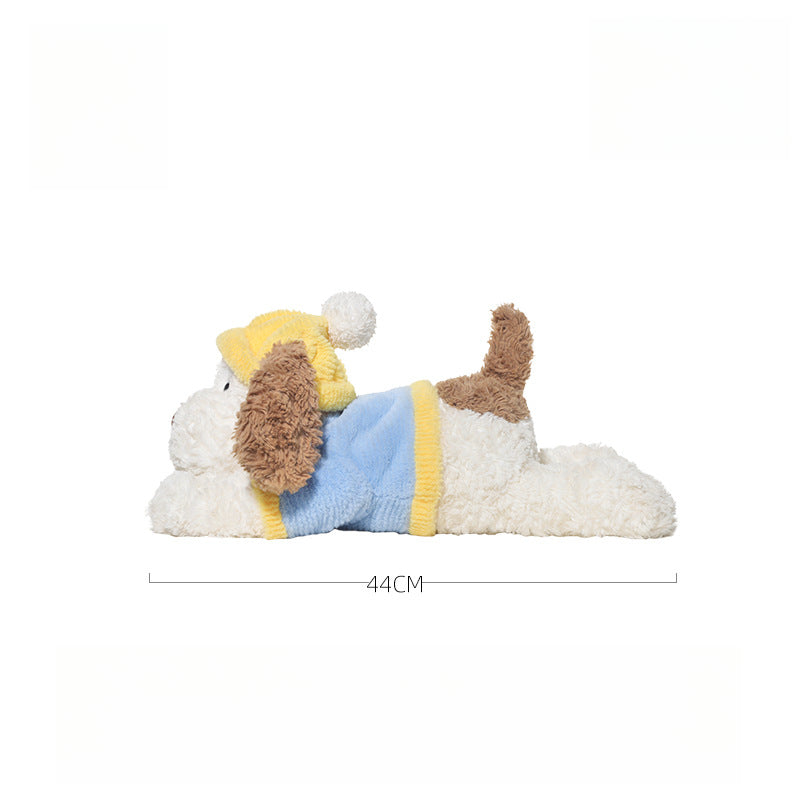 The JOOKI 44cm Lying Dog Plush Toy with Yellow Hat is a soft stuffed puppy, perfect for kids or decor. Its cute design and cuddly feel make it an ideal companion for fans of plushies.
