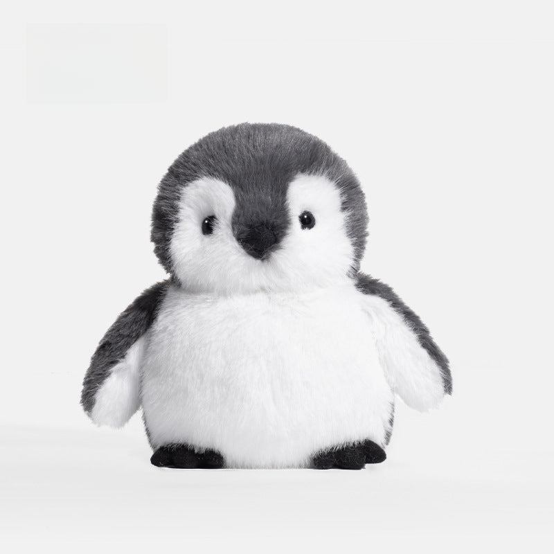 The JOOKI 20cm Baby Penguin Plush Toy features soft grey and white fur, black eyes, and a small beak—perfect as an adorable addition to nursery decor.