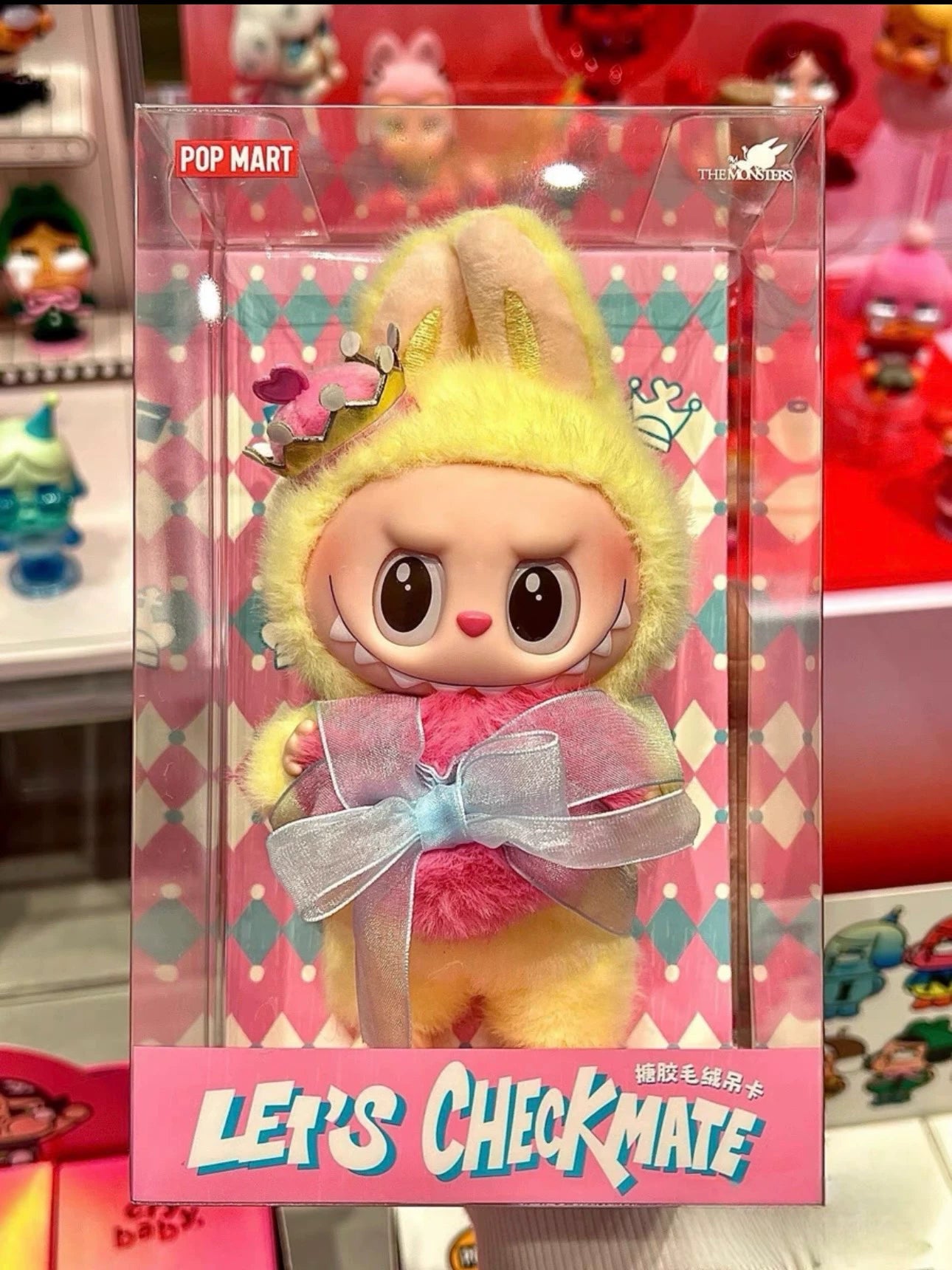 The Labubu Let's Checkmate Series – Pink Heart Bunny Plush Vinyl Doll by POP MART features Labubu in a pink bunny costume with a crown, displayed in a clear collectible box labeled LET'S CHECKMATE.