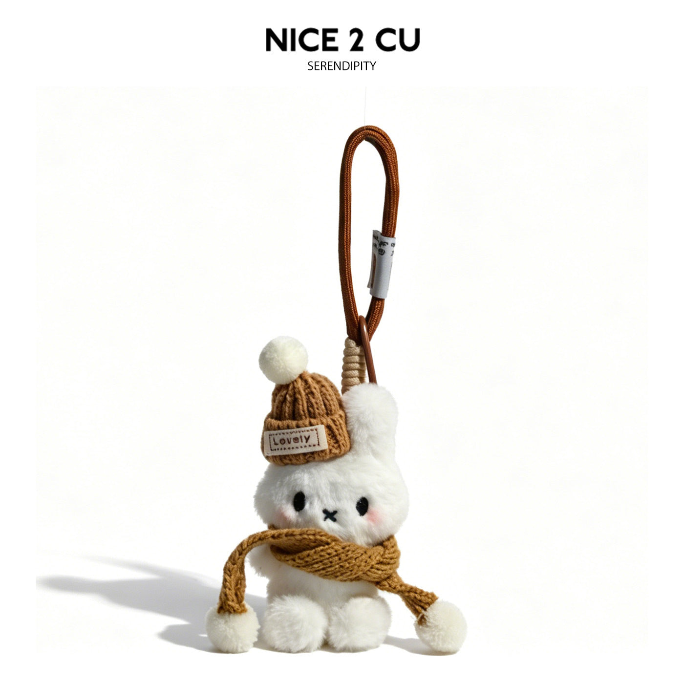 White plush rabbit bag charm wearing a caramel brown cable-knit beanie and matching scarf with pom-pom ends