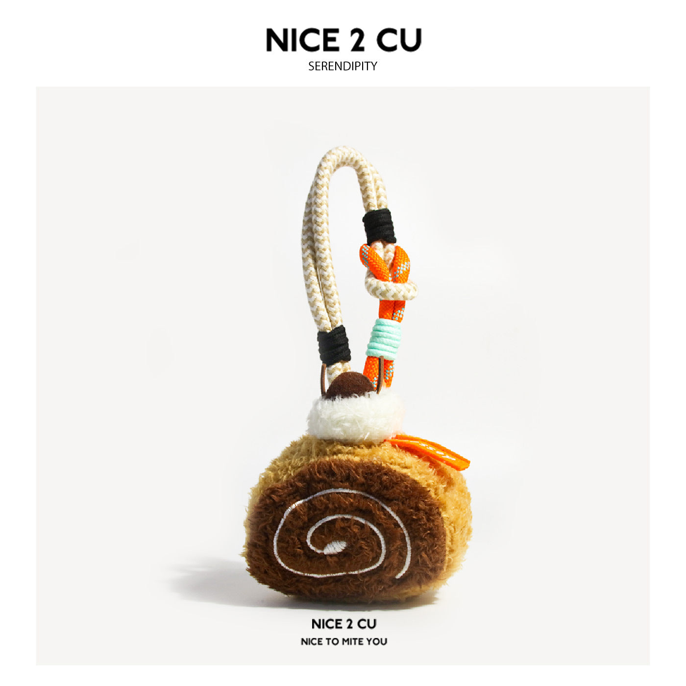 Chocolate Swiss roll plush bag charm with spiral front, cream layers, cherry accent, and rope loop