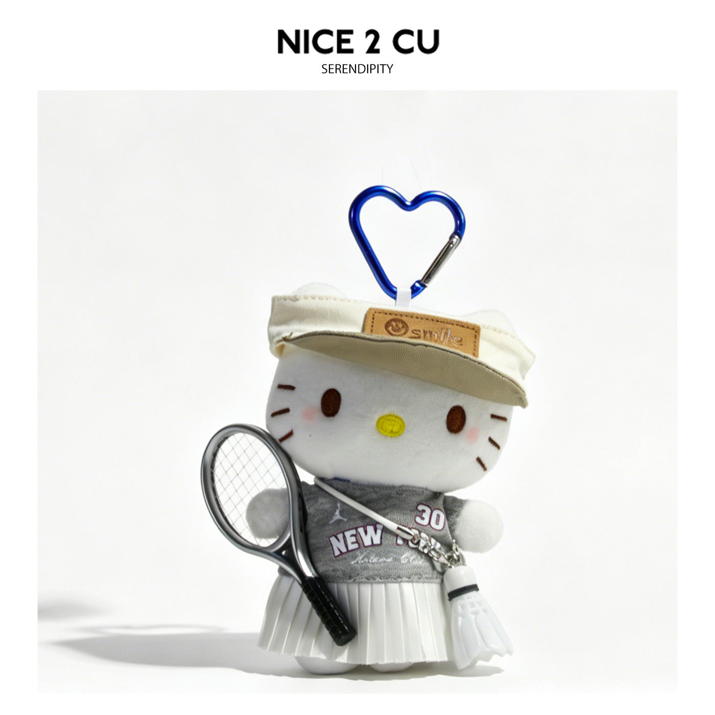 Cartoon cat plush charm in gray and white outfit attached to blue heart-shaped carabiner clip
