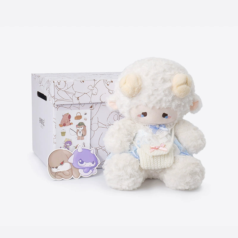 The ZEIO Dressed Lamb Plush Toy 29cm, a soft fashion sheep doll in a blue outfit, sits beside two character keychains and a decorated box—ideal as a plush collectible or nursery décor.