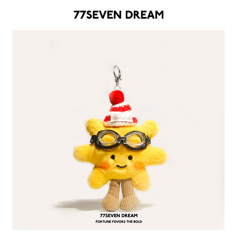 Yellow sunflower plush charm with red-and-white striped hat and black toy goggles