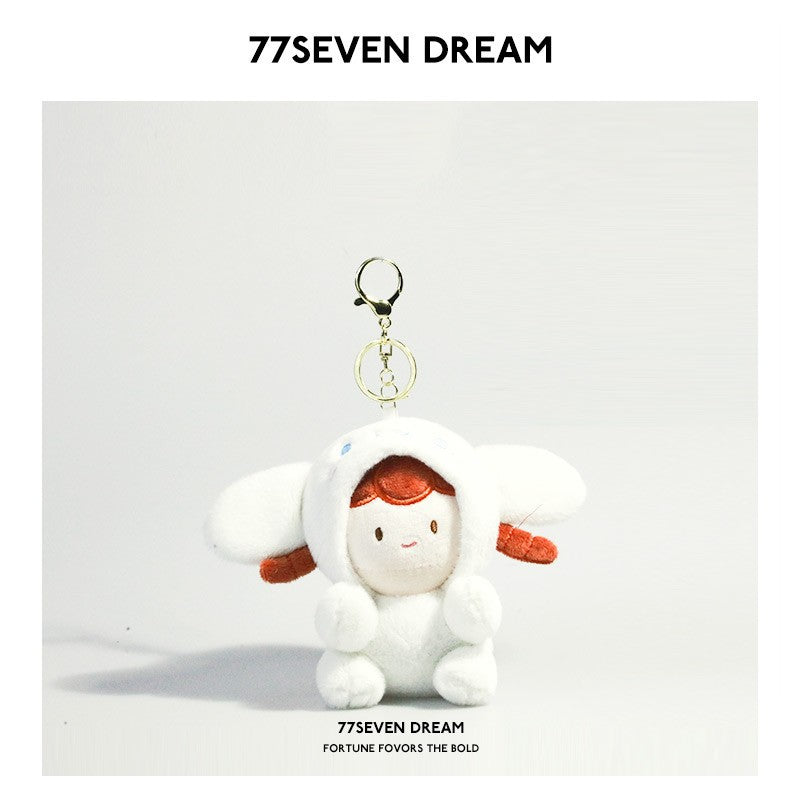 Kawaii plush keychain charm showing a girl doll in a white dog or bunny costume with large floppy ears and gold lobster clasp