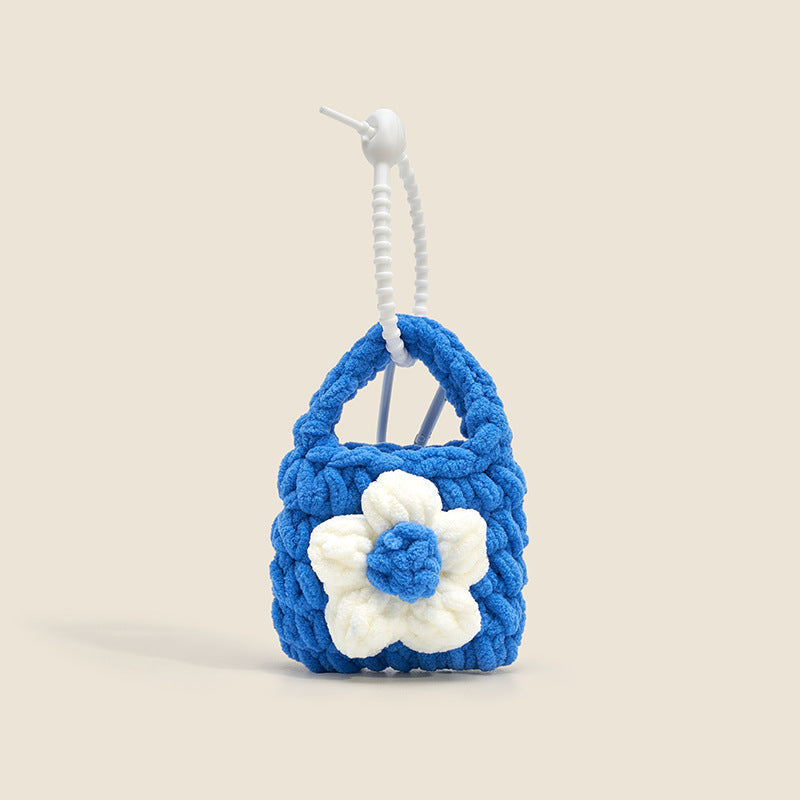 Blue plush mini bag charm with white flower applique and white coiled lanyard