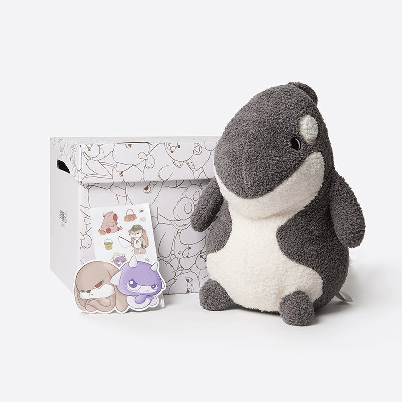 The ZEIO Orca Plush Toy 30cm – Soft Cuddly Killer Whale, a decorated white box, and two character stickers are displayed on a plain white background.
