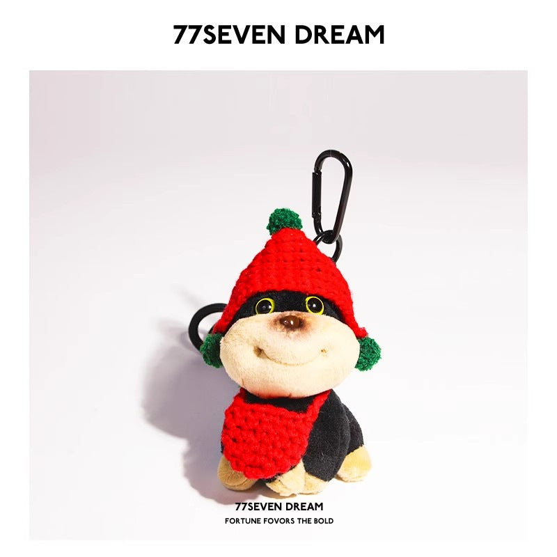 Chibi dog plush charm wearing a red knitted hat and matching red scarf accessory