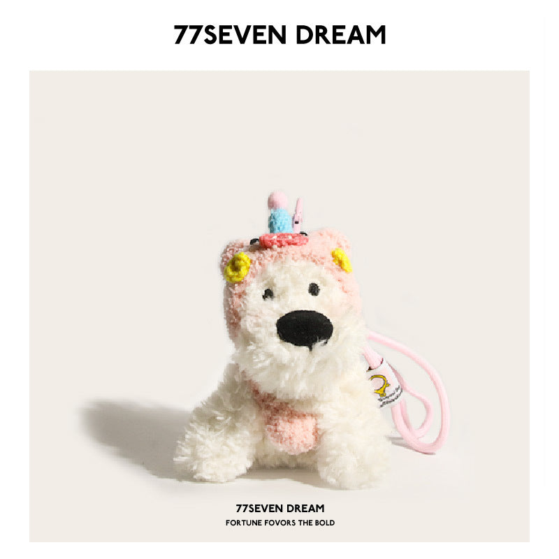 White fluffy dog plush charm in a pink pig costume hood with yellow accents and pink strap