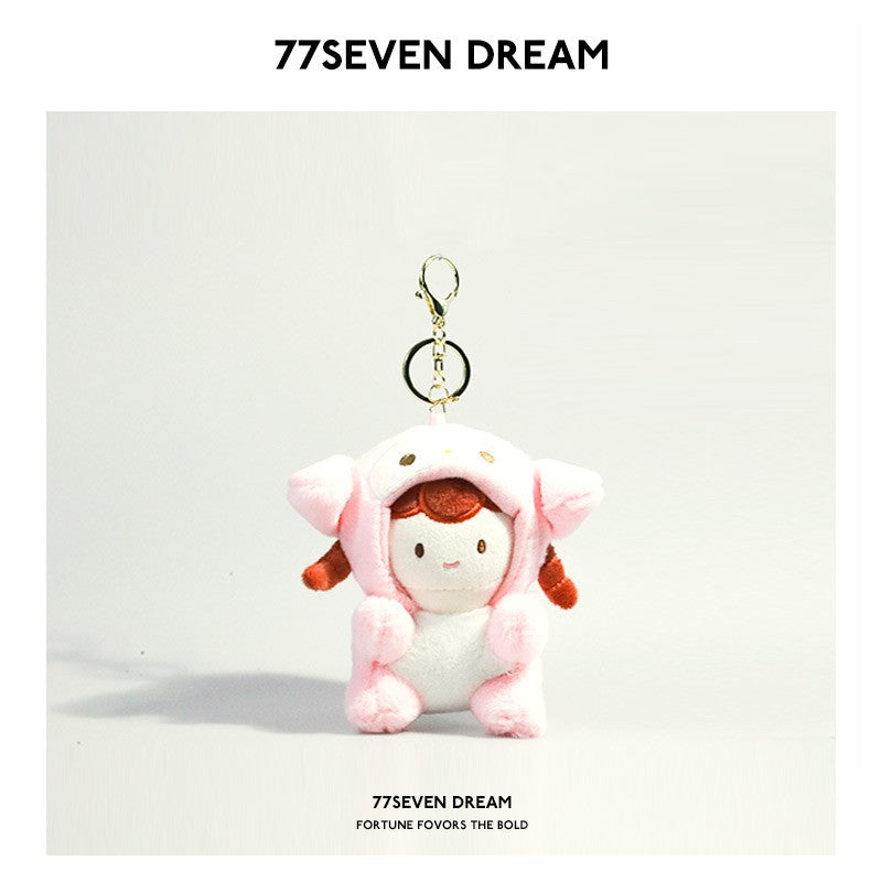 Kawaii plush keychain charm featuring a girl doll in a pink animal hood costume with gold ring attachment