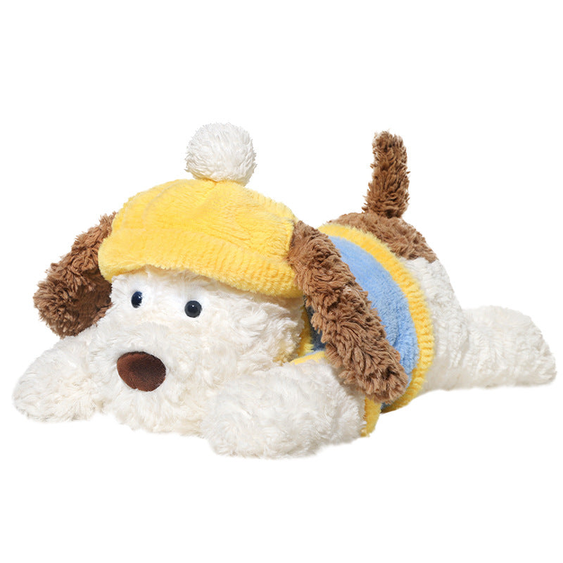The JOOKI 44cm Lying Dog Plush Toy features soft brown ears and tail, a yellow pom-pom hat, and a yellow-blue sweater. This cute stuffed puppy lies down with front paws stretched forward—perfect for kids or decor.