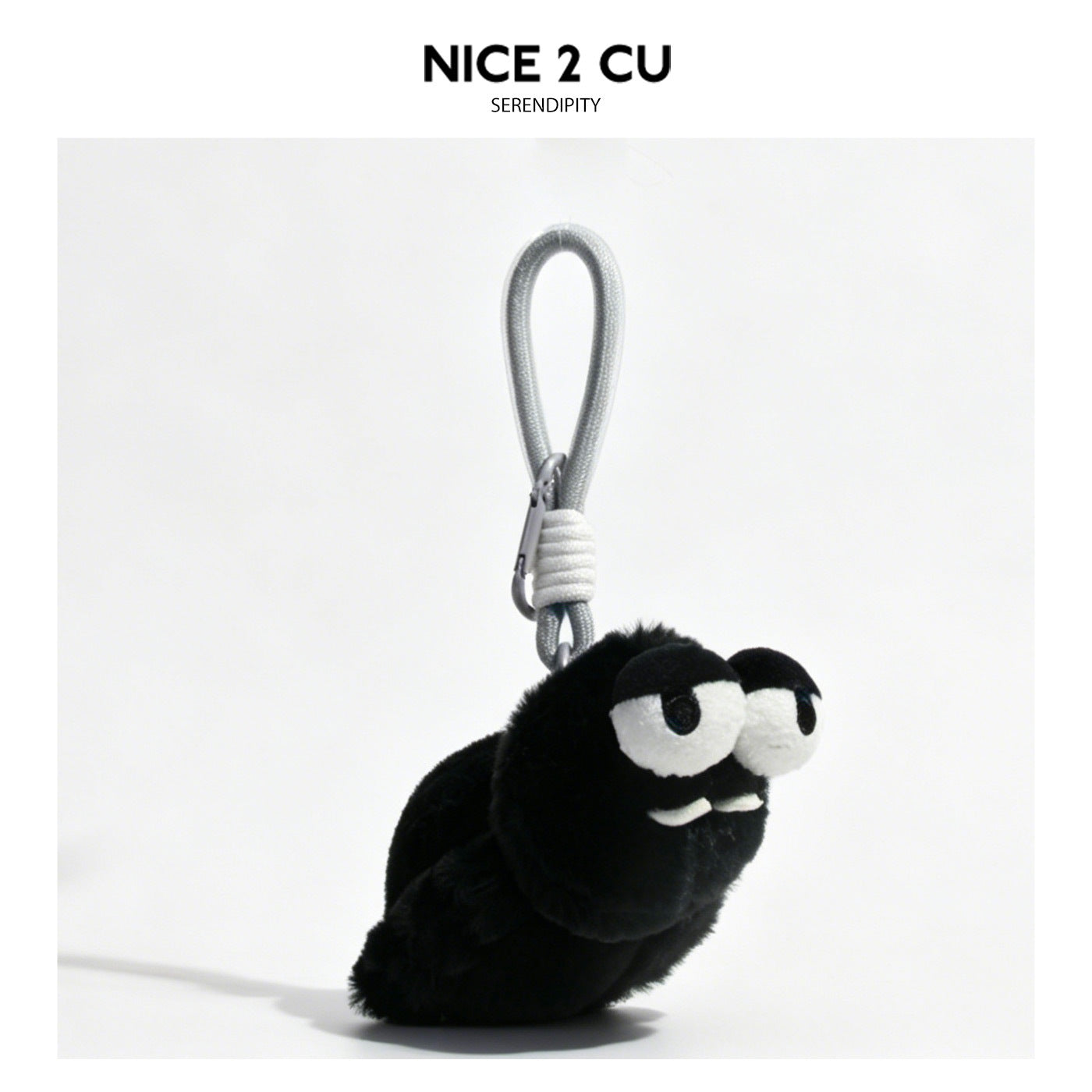 Black fuzzy spider plush keychain with oversized sleepy white eyes and gray hanging loop