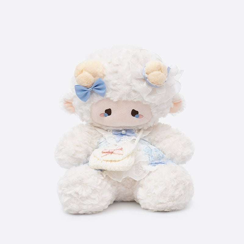 The ZEIO Dressed Lamb Plush Toy (29cm) features soft cream fur, a blue outfit, and a tiny purse—ideal as a collectible or nursery décor. This adorable fashion sheep doll sits elegantly against a plain white background.