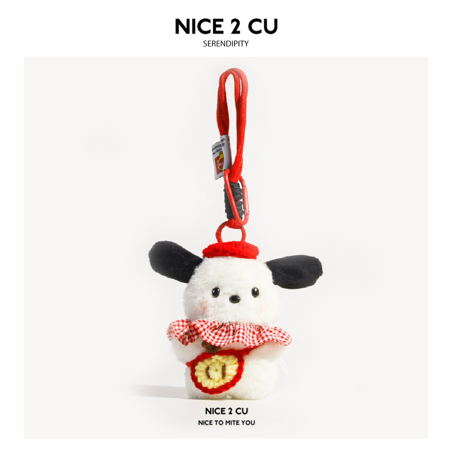 White dog plush bag charm with black ears, gingham ruffle collar, and red apple-shaped front detail