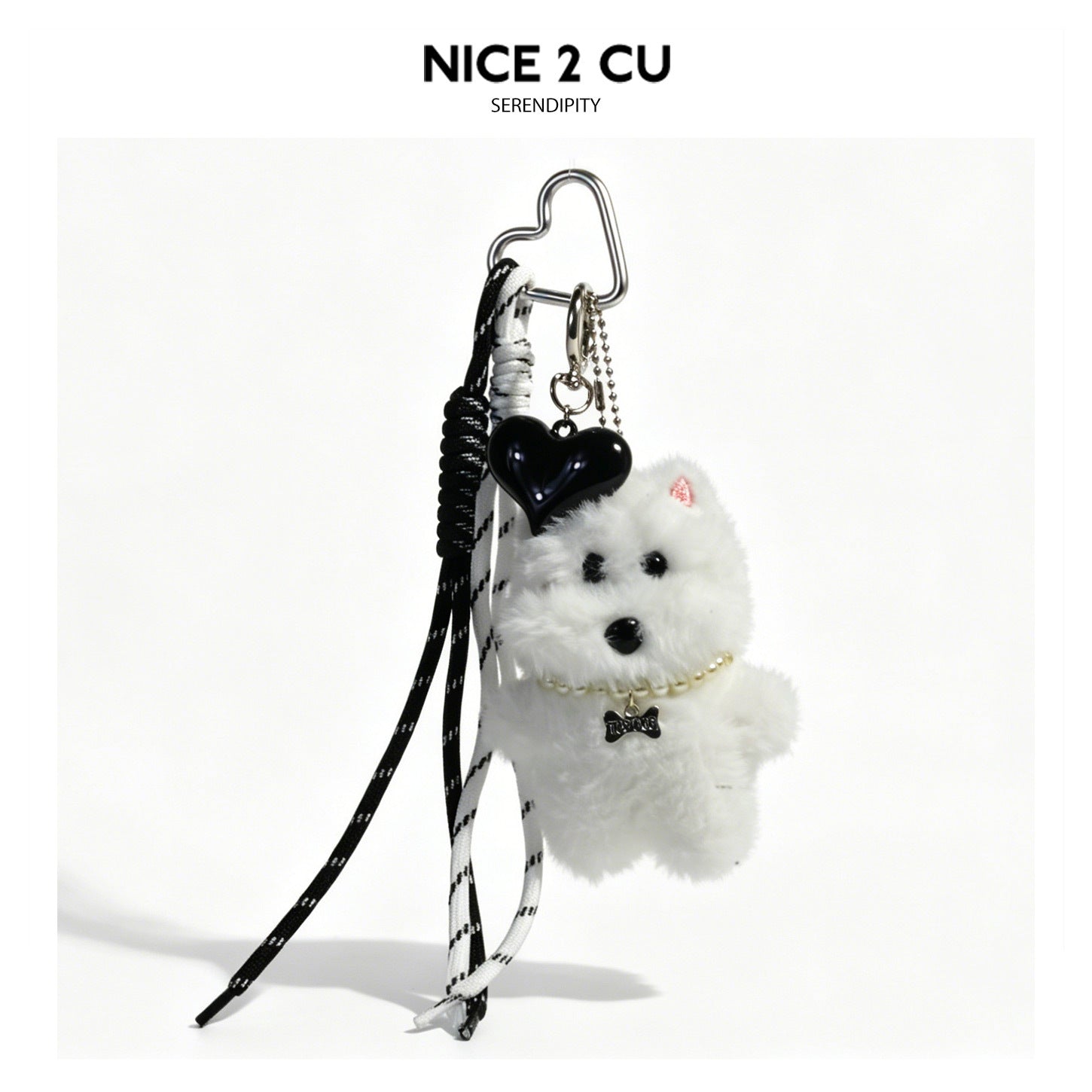 White plush dog bag charm with pearl necklace, black heart charm, and patterned cords on heart-shaped silver clip