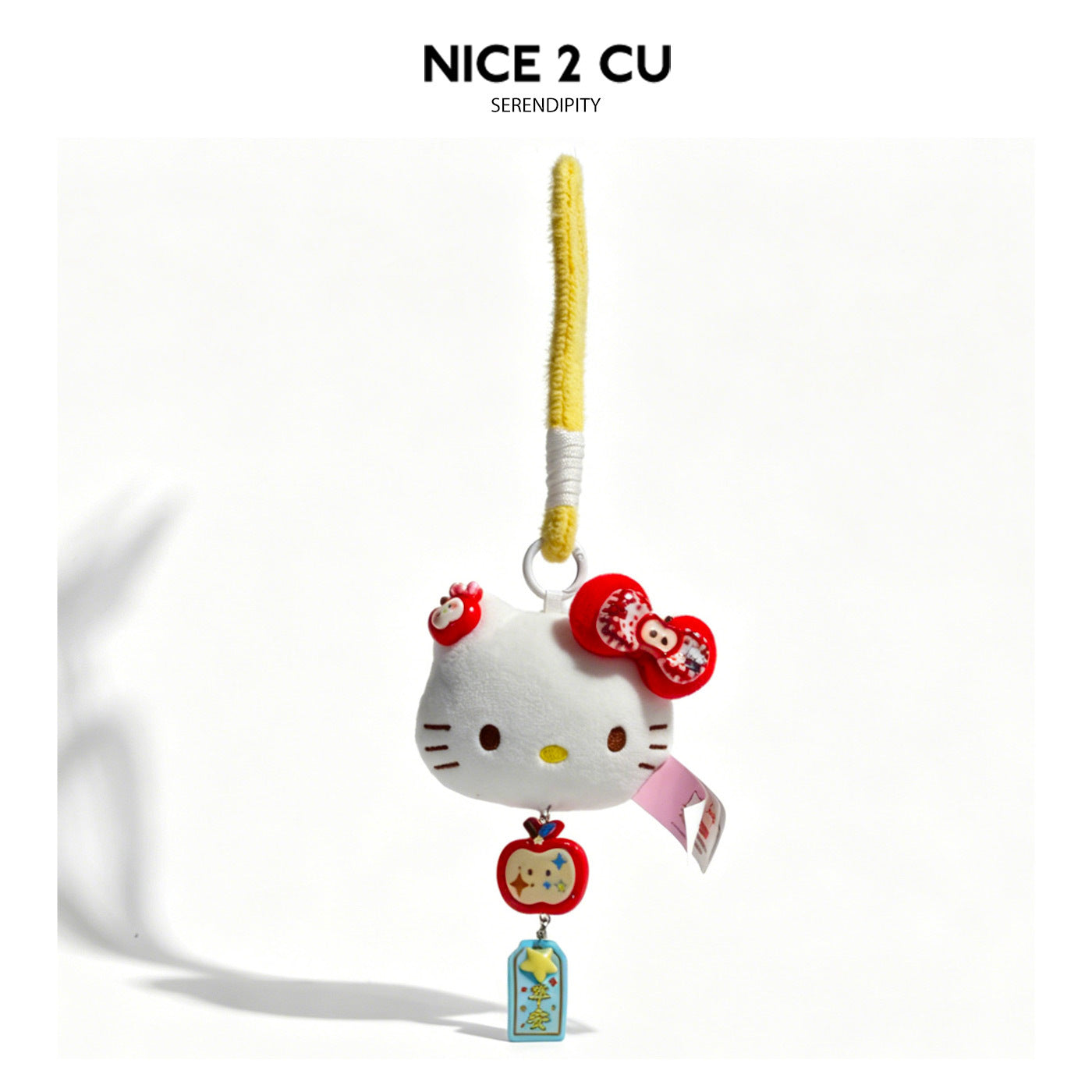 White cat-face plush charm keychain with red bow accents and blue Peace tag on yellow braided cord