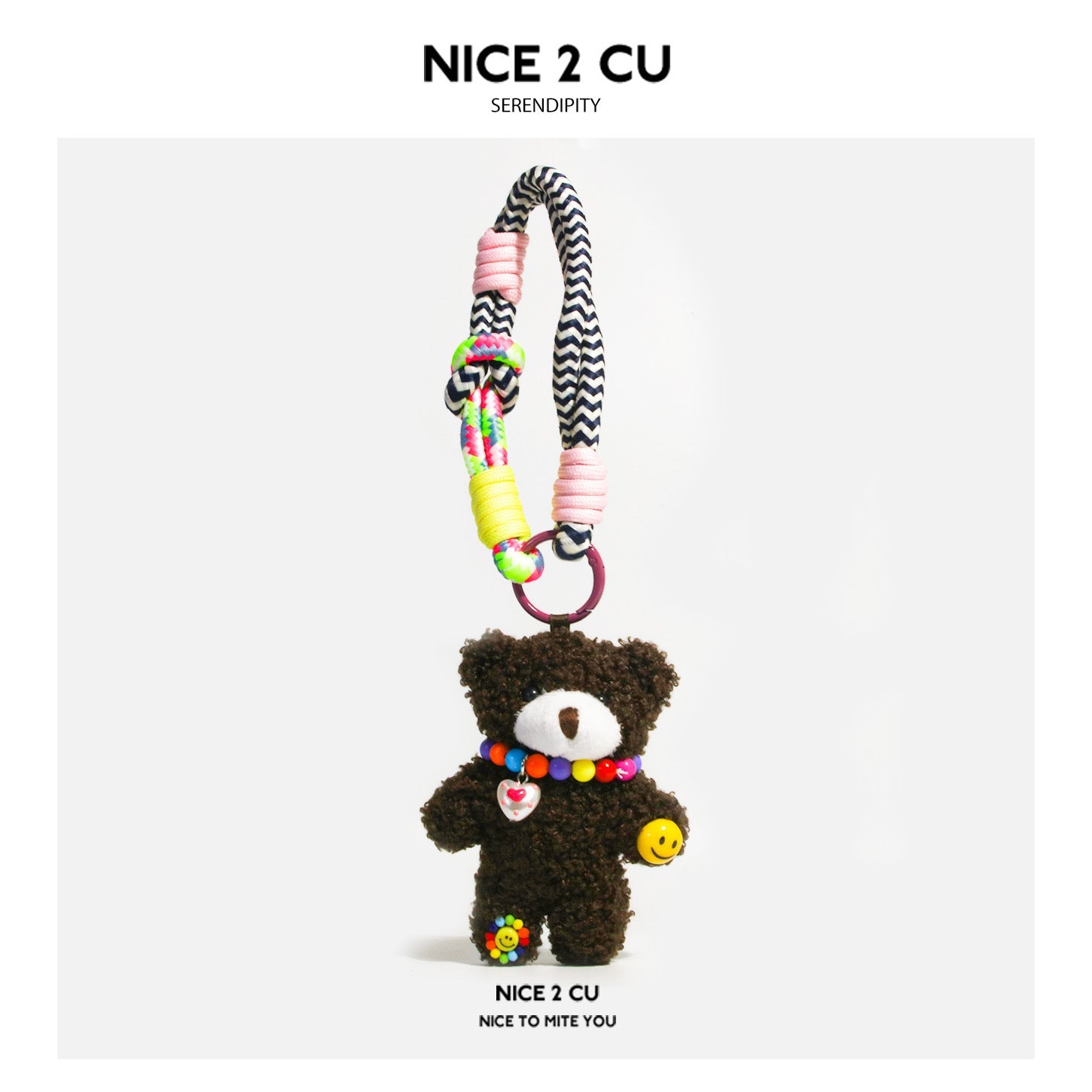 Dark brown curly-plush teddy bear bag charm with multicolor bead necklace, heart pendant, smiley charm, and braided chevron c