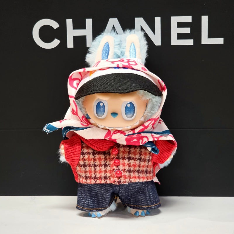 The ZoDoll Labubu Doll, wearing a tweed jacket, denim shorts, scarf, and cap 4-piece set, stands against a black background with the word CHANEL in white letters.