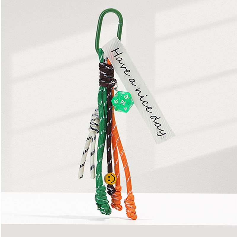Green carabiner bag charm keychain with green, orange, and white braided rope strands and woven Have a nice day tag