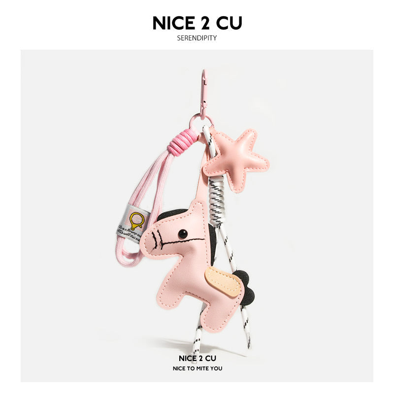 Pink leather-look pony and star charm keychain with beige saddle accent and white cord