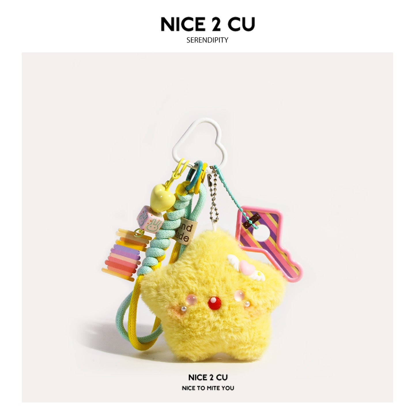 Yellow kawaii star plush bag charm with pink blushing face, cloud hook clasp, rainbow disc charm, and mint braided cord — Pin
