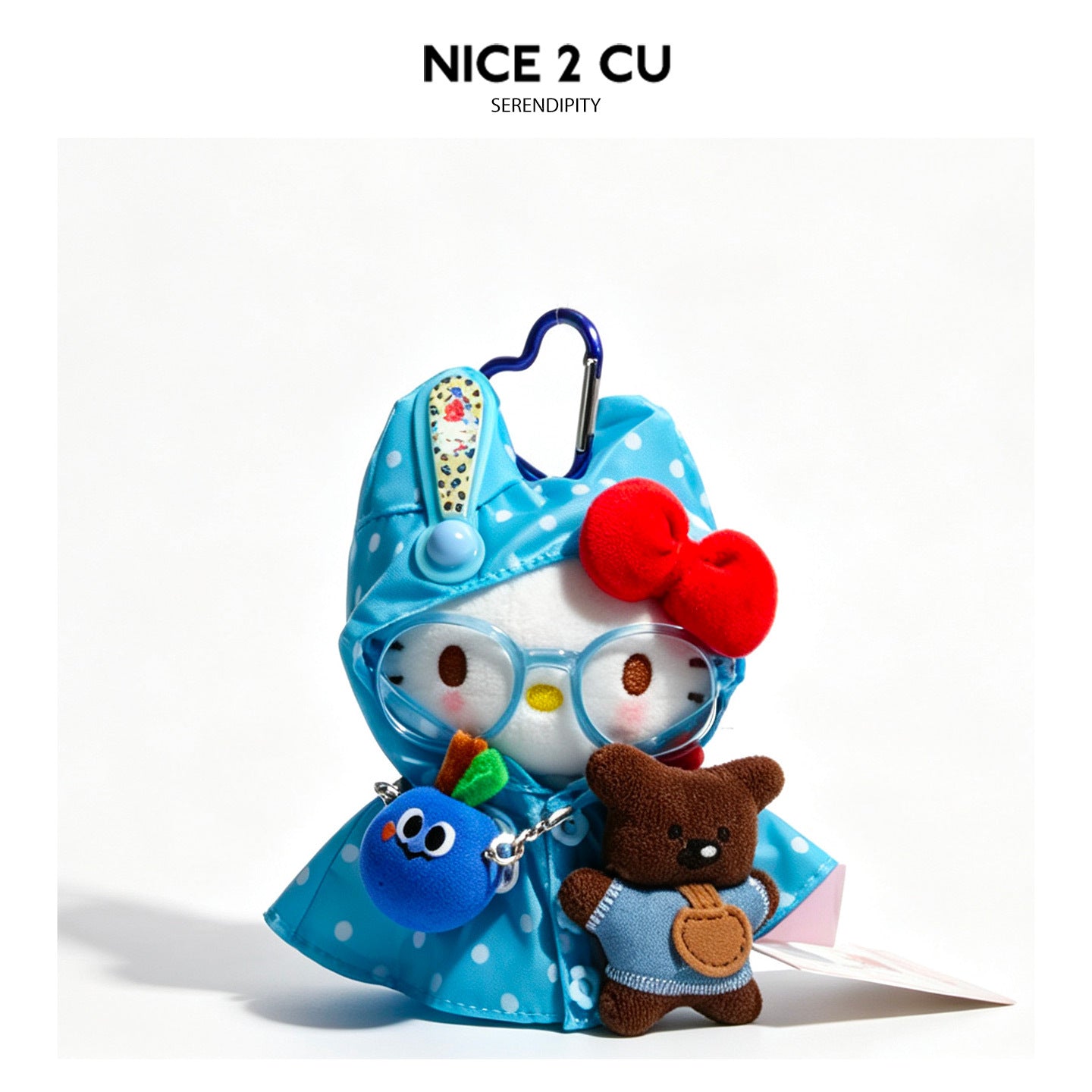 Light blue polka-dot raincoat kawaii cat plush charm with red bow, round glasses, and heart carabiner clip holding a small br