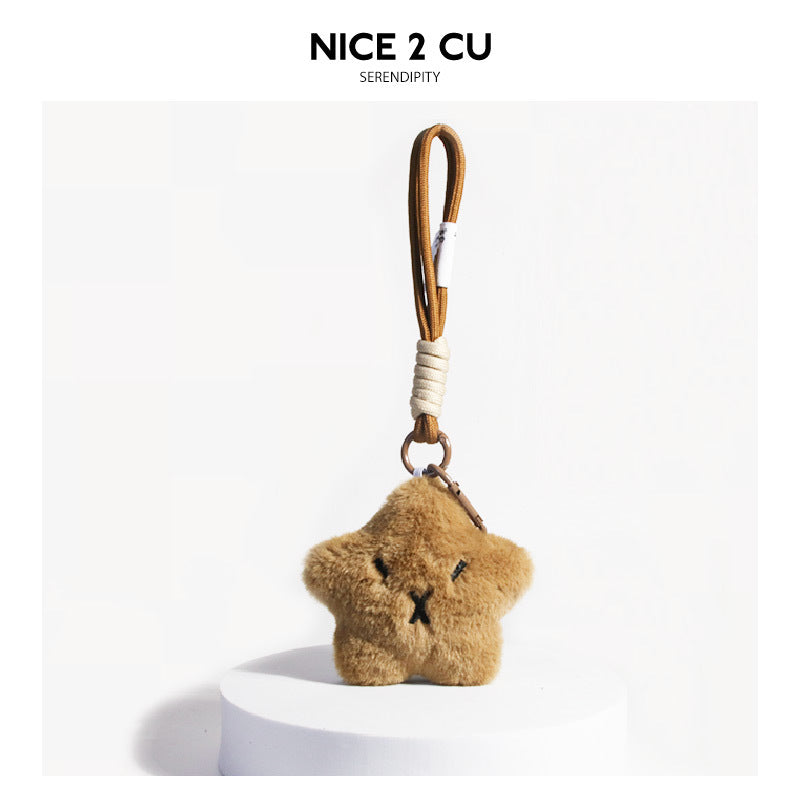 Caramel brown star-shaped capybara plush bag charm with braided cord loop and antique-tone metal split ring