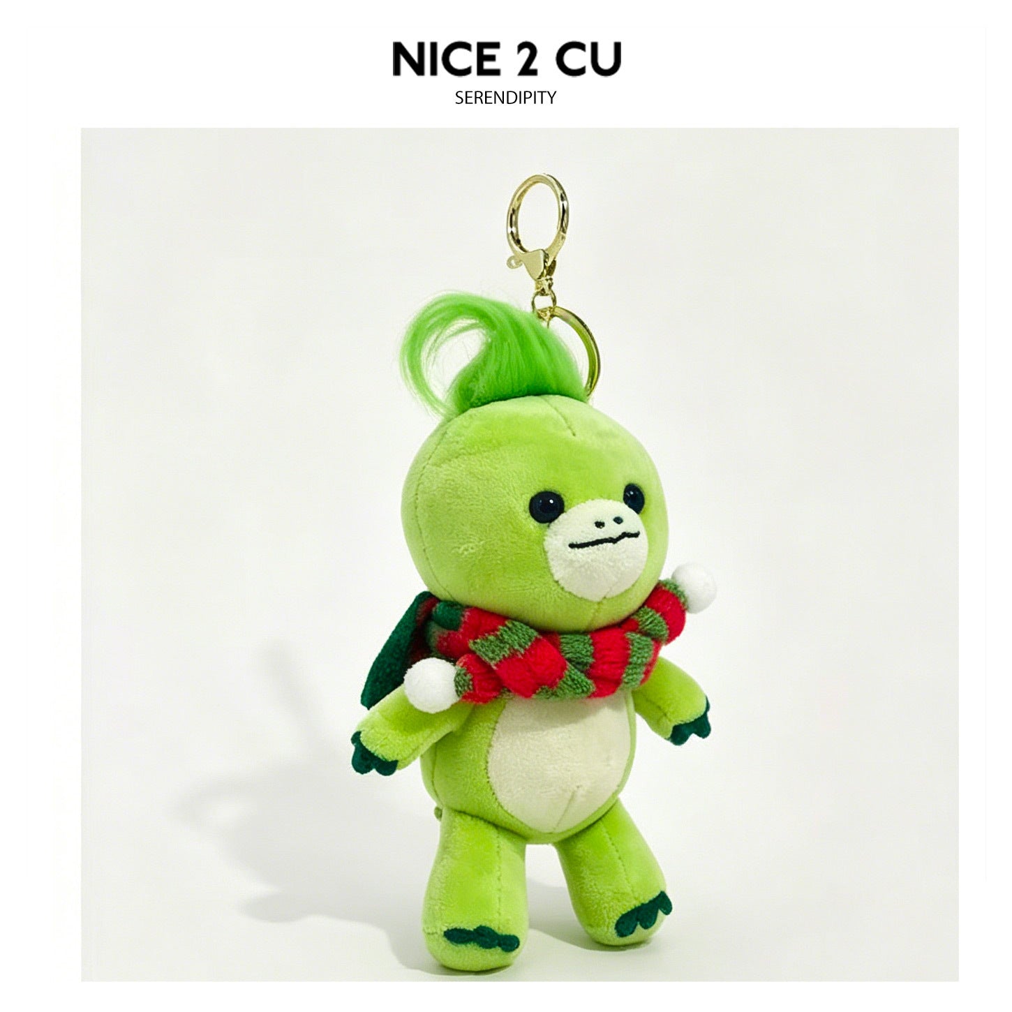Green turtle plush keychain charm wearing a red-and-green striped scarf with gold clip attachment