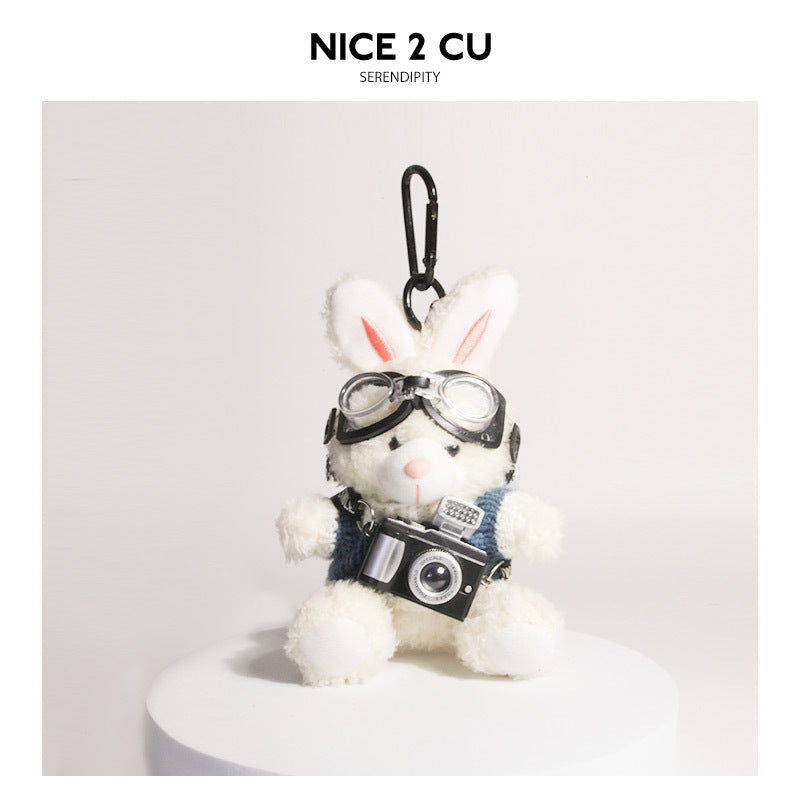 White plush rabbit keychain in blue-and-white knit sweater with goggles and miniature camera pendant