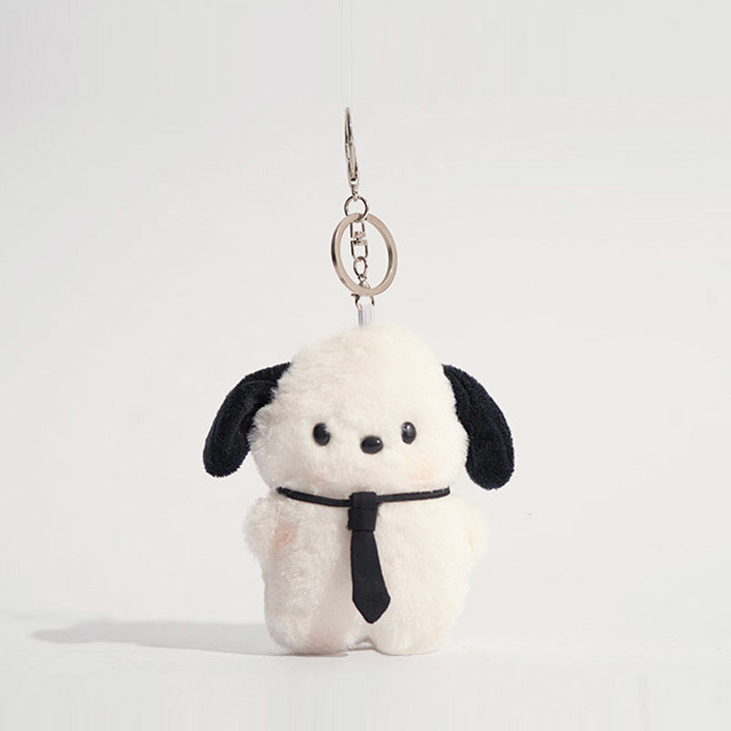 White plush dog keychain charm with black ears wearing a black necktie and no goggles