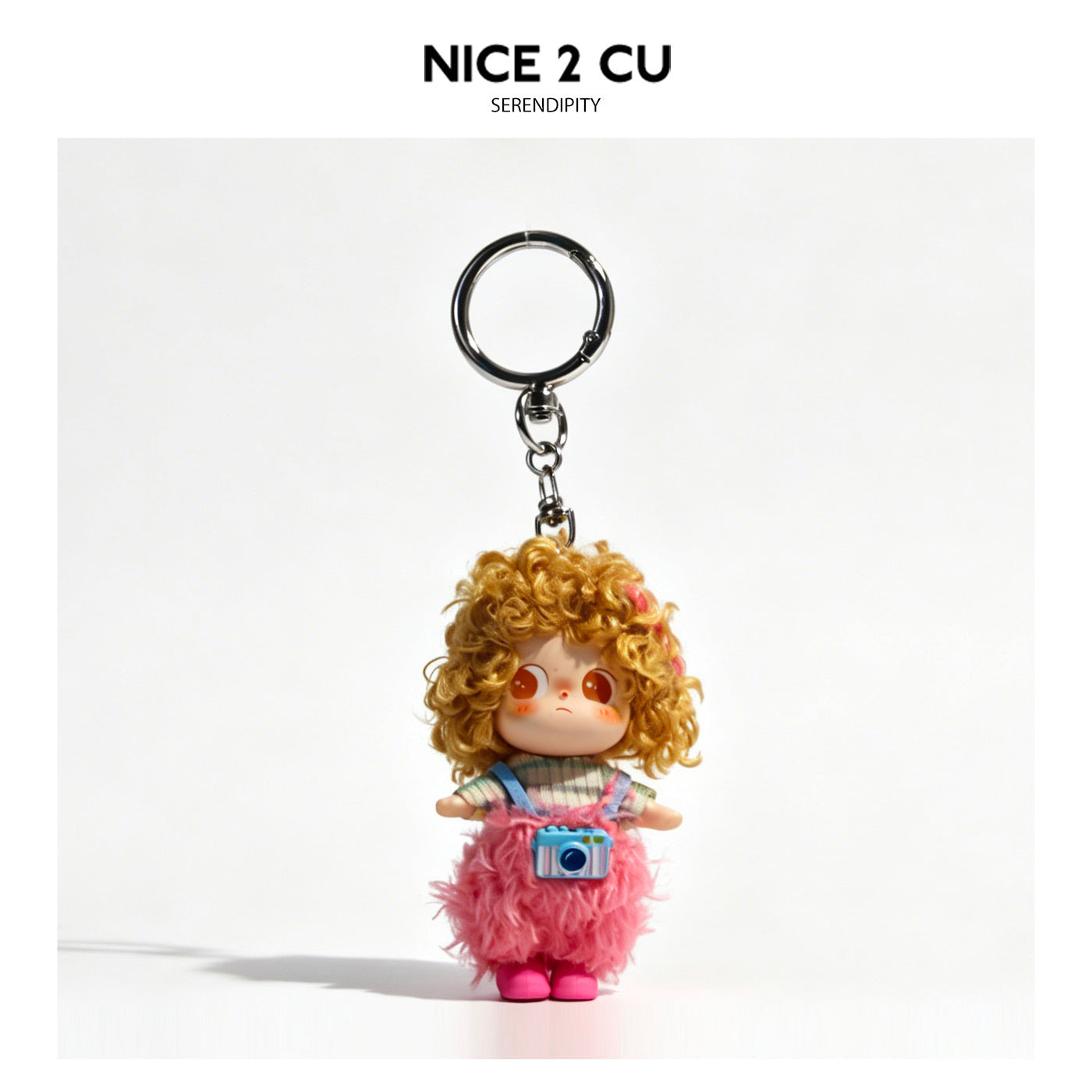Kawaii doll keychain charm with curly hair, striped top, fluffy pink skirt, pink shoes, and blue camera accessory on silver k