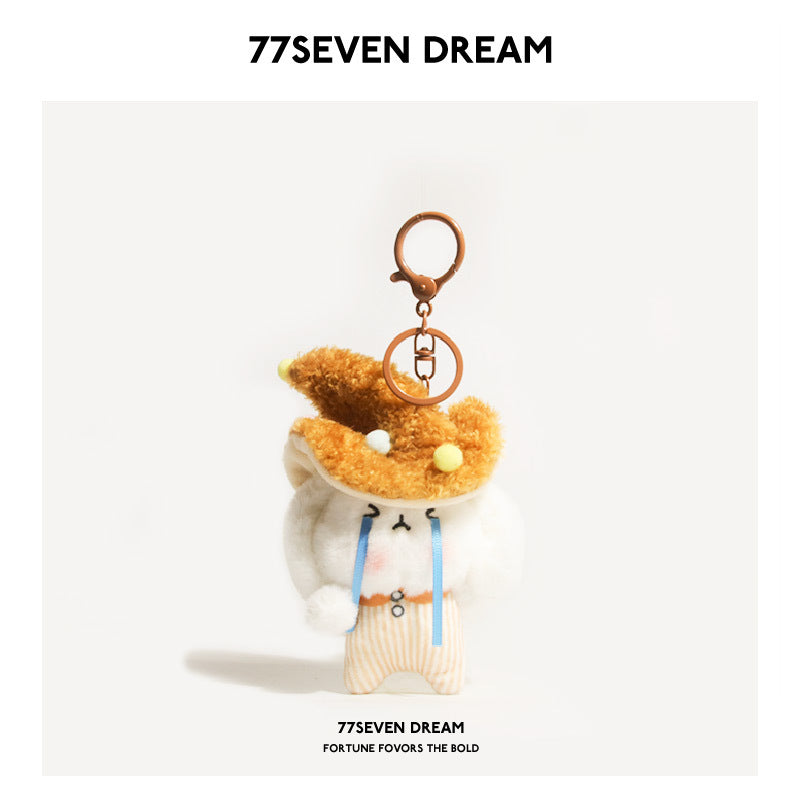 White rabbit plush keychain charm wearing a brown-orange mushroom hat with pom-pom dots and orange striped outfit, metal keyr